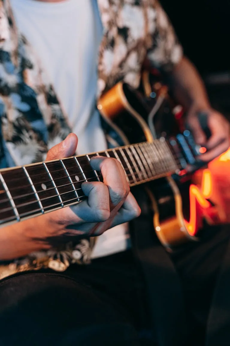 A musician skillfully playing an electric guitar during a live performance, creating a vibrant musical atmosphere.
