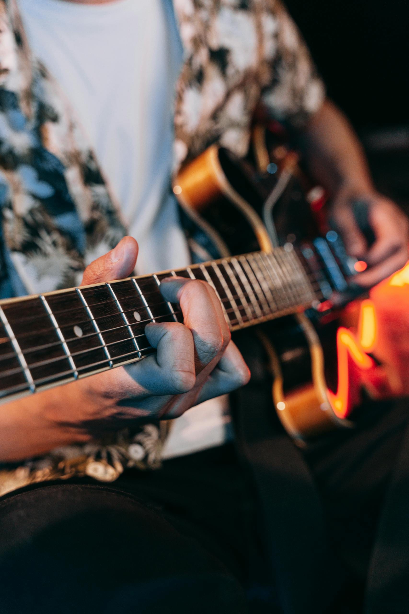 A musician skillfully playing an electric guitar during a live performance, creating a vibrant musical atmosphere.