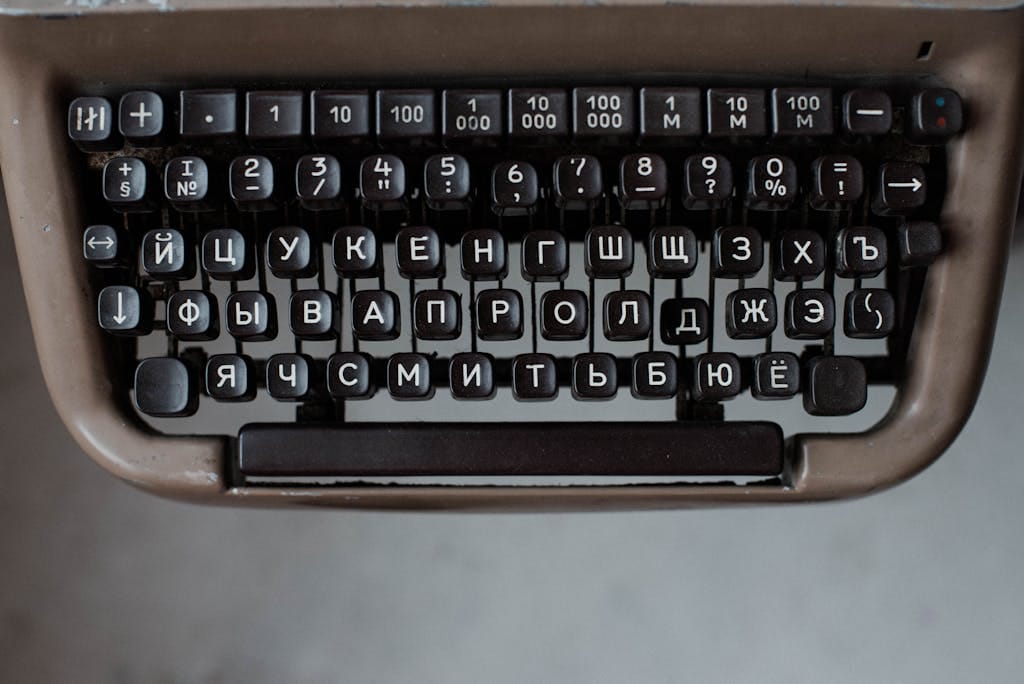 Close-up of a vintage Russian typewriter keyboard with Cyrillic alphabet.